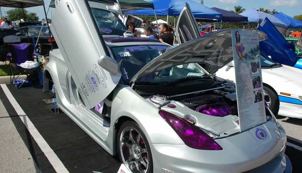 A costum built car with scissor-doors and hood open